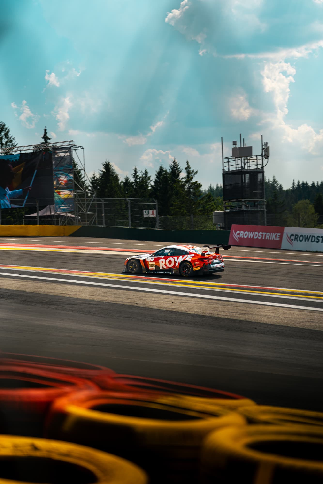 Distant car framed between the circuit structures at Spa